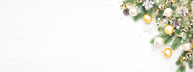 Classic Christmas composition with fir branches, white and golden baubles, golden serpentine and...