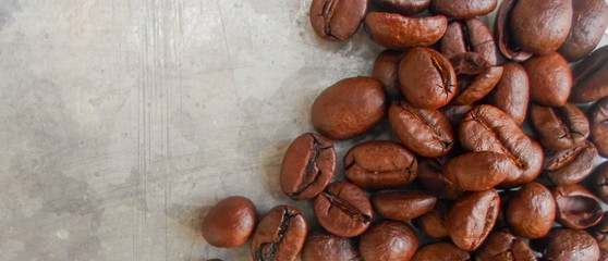 roasted coffee beans on a gray background, can be used as a background. large grains of coffee