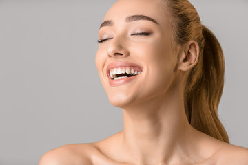 Millennial woman with fresh skin and healthy white teeth