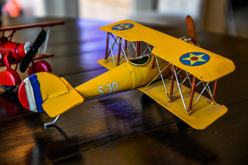 a toy airplane and a model train on a table.