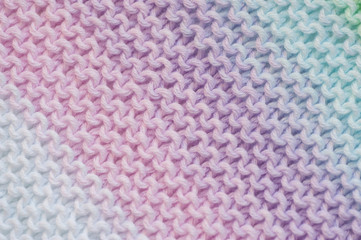 Fragment of handmade seamless knitted patterns in mixed pastel colors
