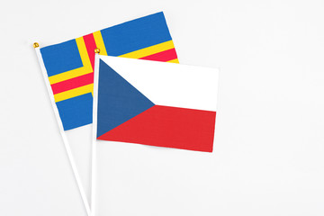 Czech Republic and Aland Islands stick flags on white background. High quality fabric, miniature national flag. Peaceful global concept.White floor for copy space.