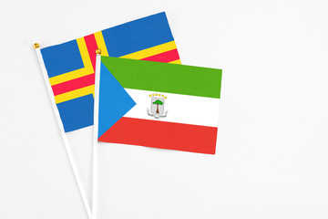 Equatorial Guinea and Aland Islands stick flags on white background. High quality fabric, miniature...