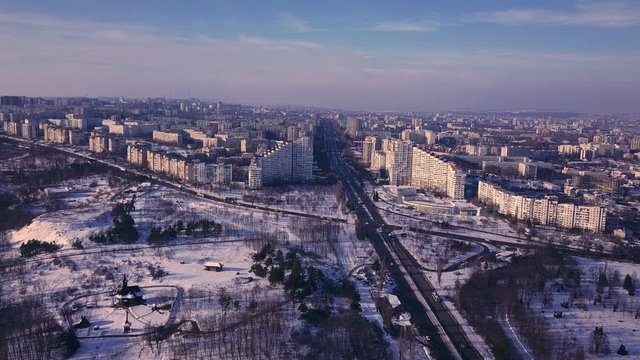 Top view of city in winter at sunset on sky background. Aerial drone videography concept. 4K. Kishinev, Republic of Moldova.