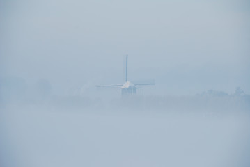 Fototapeta na wymiar windmill in fog 