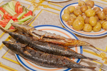 Smoked mackerel cooked on a plate laid for dinner table