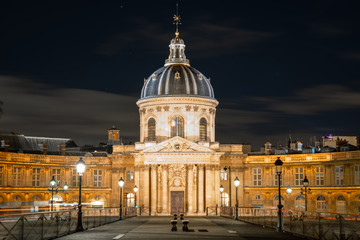 Obraz premium The Institute of France in night Paris cityscape