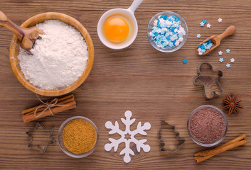 ingredients and kitchen tools for dessert baking on wooden background