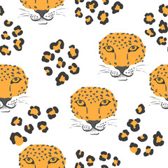 Vector seamless pattern with leopard heads and print. © Afanasia