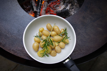 grill plate small baby potatoes rosemary top view