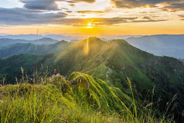 Group of tourists climbing up the mountain top with a blue sky background in Thongphaphum National Park, ,Khao Chang Phueak, Thailand.