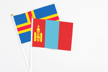 Mongolia and Aland Islands stick flags on white background. High quality fabric, miniature national flag. Peaceful global concept.White floor for copy space.