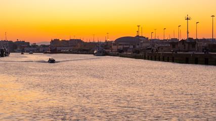 Little boat for fishing in Fiumicino port at sunrise.