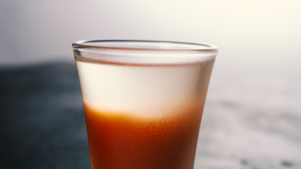 Selective focus, alcoholic cocktail. Close-up of a transparent layer of vodka in a cocktail