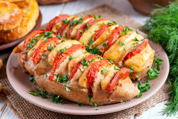 Chicken fillet baked with tomatoes and cheddar cheese