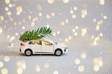 White toy car with a Christmas tree on the roof
