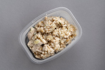 Oatmeal with chicken breast in a plastic container. Convenient to take with you.