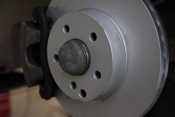 new brake disc on a car in a car service