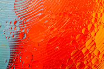 Oil drop on water with colerful to creation design background.