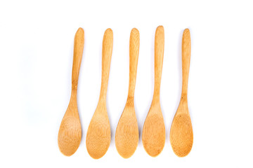 Five shallow bamboo spoons in a row