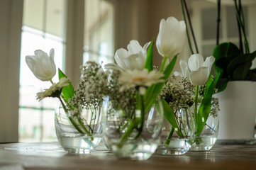 bouquet of white flowers in a vase on wooden table