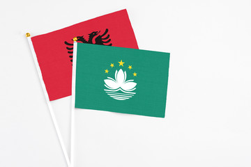 Macao and Albania stick flags on white background. High quality fabric, miniature national flag. Peaceful global concept.White floor for copy space.