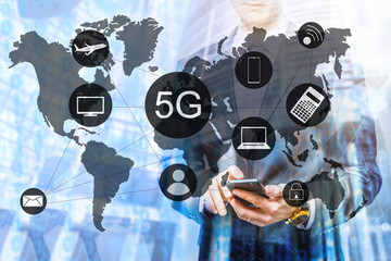 The double exposure image of the business man using a smartphone during sunrise overlay with cityscape image. The concept of modern life, business, city life and internet of things