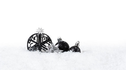 Black christmas balls with snow isolated on white background
