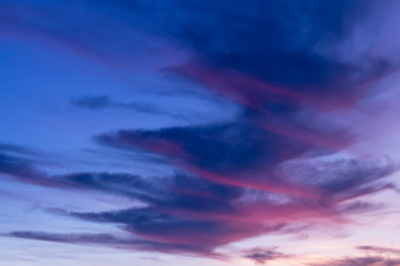 dramatic sky with Spiral clouds.  Reds and purple fill the picture