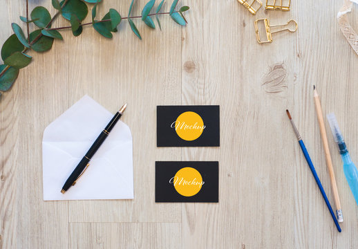 2 Black Horizontal Business Cards with Envelope and Eucalyptus Mockup