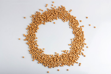 Dried chickpeas in the shape of a round frame on a white background
