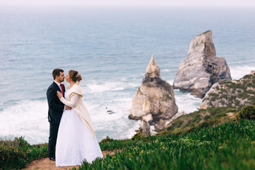 profile newlyweds in each other's arms on the background of the