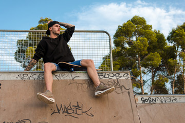 Young man with a skate in a skating court