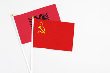 Soviet Union and Albania stick flags on white background. High quality fabric, miniature national flag. Peaceful global concept.White floor for copy space.