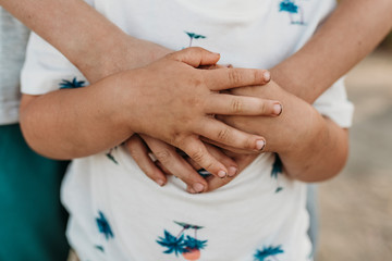 Close up of brothers hands intertwined together