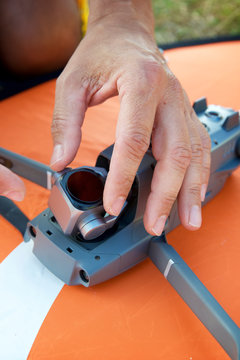 Close-up of a man preparing a drone to fly.