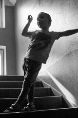 boy plays in the dark porch