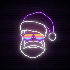 Santa Claus neon sign. Hipster wearing in shutter glasses and Santa Claus hat. Bright Christmas vector illustration. © greens87