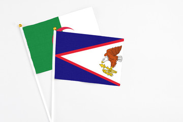 American Samoa and Algeria stick flags on white background. High quality fabric, miniature national...