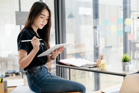 Young businesswoman using tablet searching infomation marketing