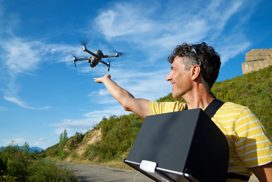 A man driving a drone in the Pyrenees.