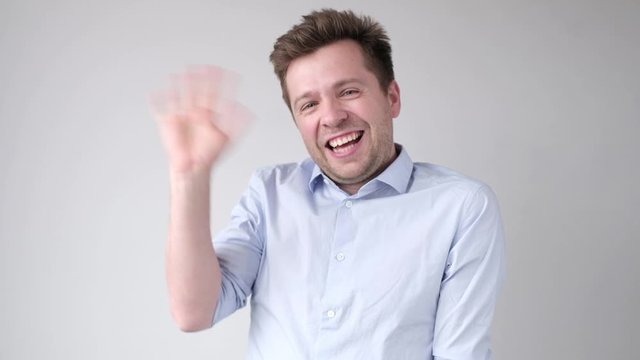 A man shows his hand hello