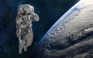 Astronaut in orbit of the planet Earth. Solar system. Science fiction. Elements of this image...