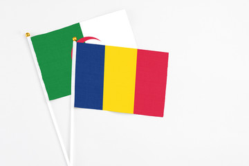 Chad and Algeria stick flags on white background. High quality fabric, miniature national flag. Peaceful global concept.White floor for copy space.