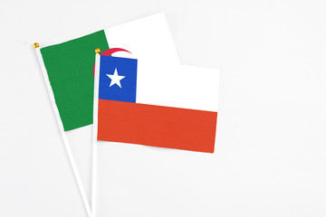 Chile and Algeria stick flags on white background. High quality fabric, miniature national flag. Peaceful global concept.White floor for copy space.