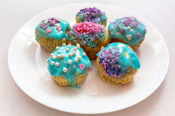 Homemade cupcakes with colorful icing on a plate