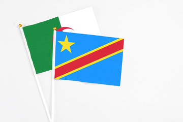 Congo and Algeria stick flags on white background. High quality fabric, miniature national flag. Peaceful global concept.White floor for copy space.