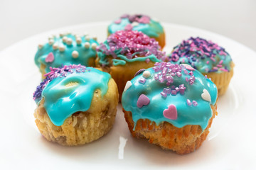 Homemade cupcakes with colorful icing on a plate