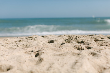 beaches sand in focus ocean view and waves summer day