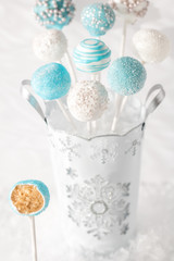 Blue and white cake pops with bite out.